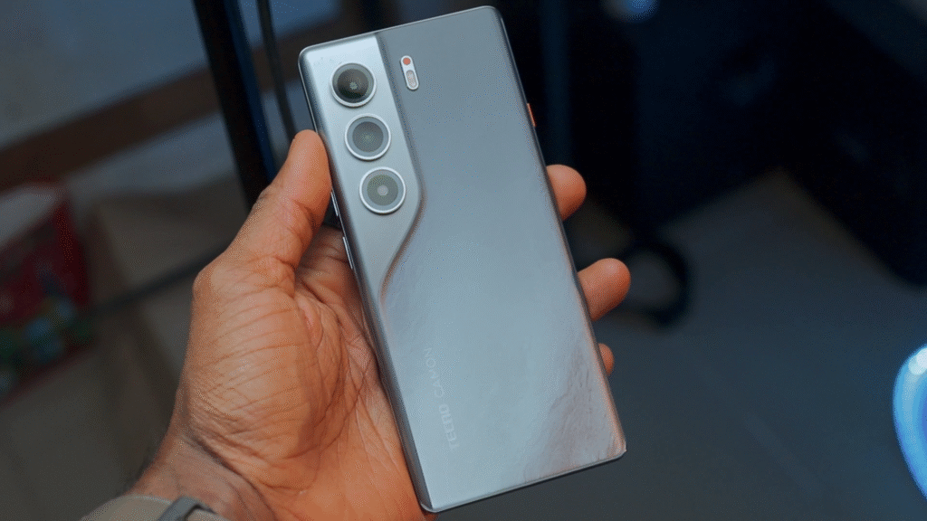 A person holding the Tecno Camon 40 Pro 4G smartphone, showcasing its sleek design and camera layout on the back.
