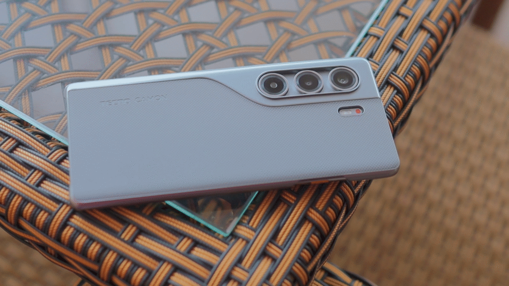 The back of the Tecno Camon 40 Pro 4G smartphone, showcasing its sleek design and triple camera setup on a woven surface.